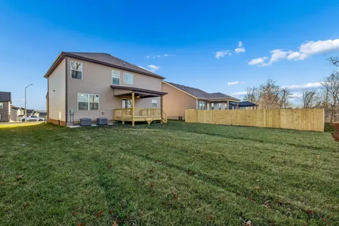 a view of backyard with wooden fence