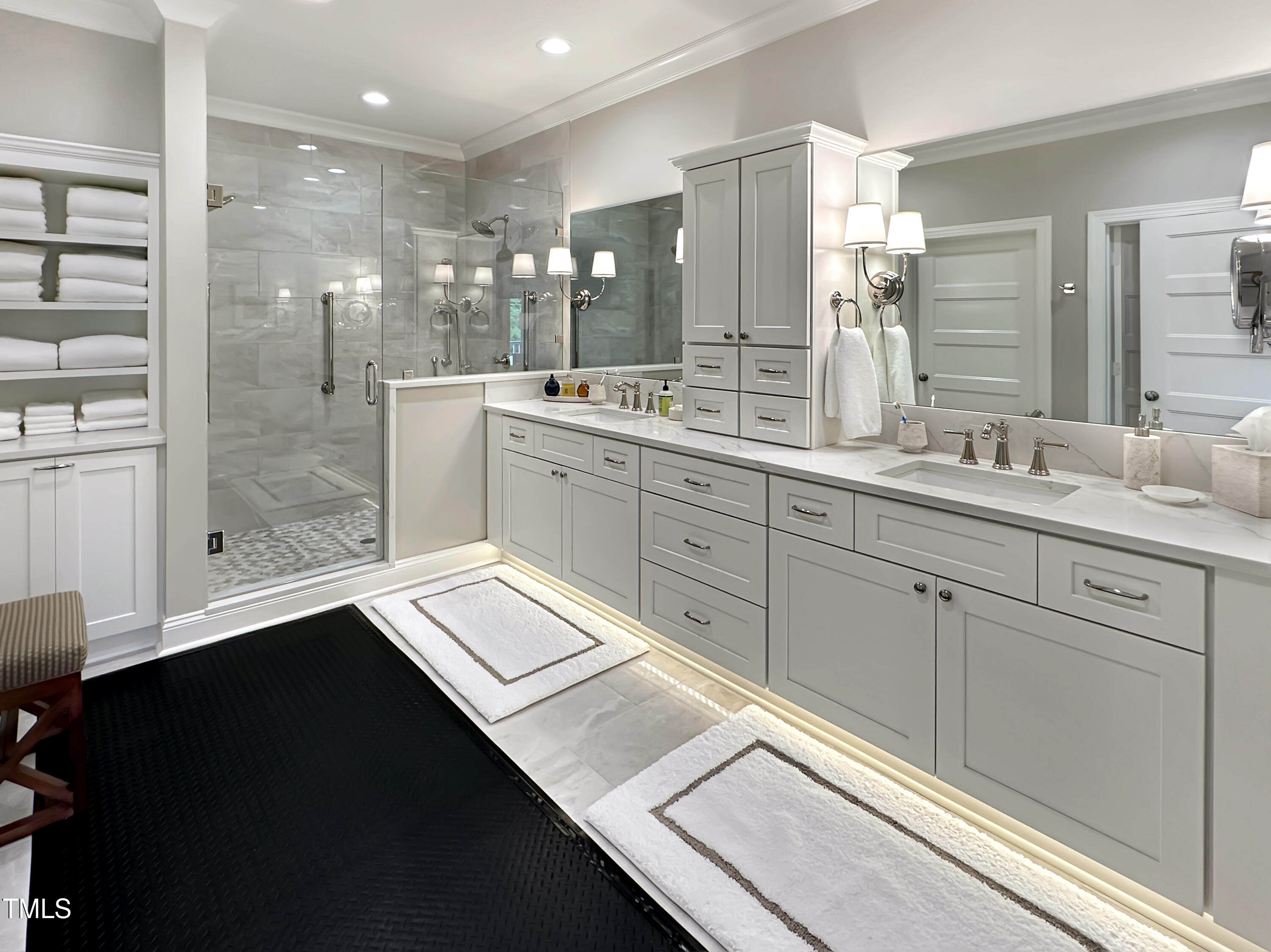 8589 McGhees Mill Road Semora, NC 27343 - Photo 19 of 67 a bathroom with a double vanity sink a mirror and a shower