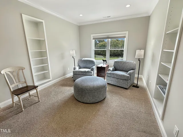 a view of a a dining room with furniture window and wooden floor