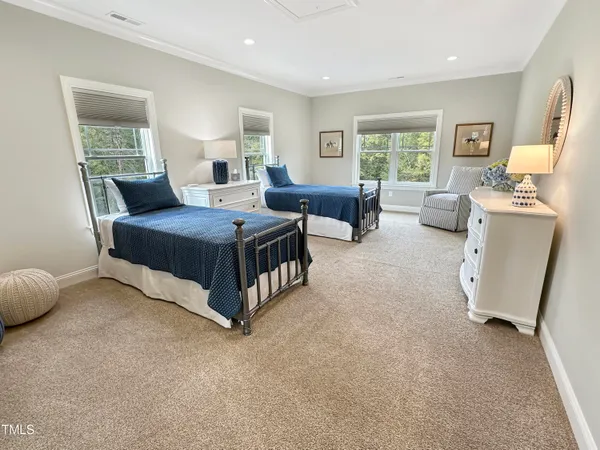 a spacious bedroom with a bed and a window