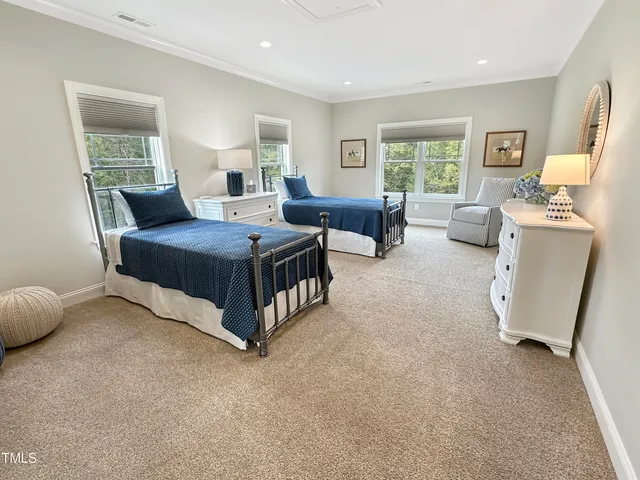 a spacious bedroom with a bed and a window