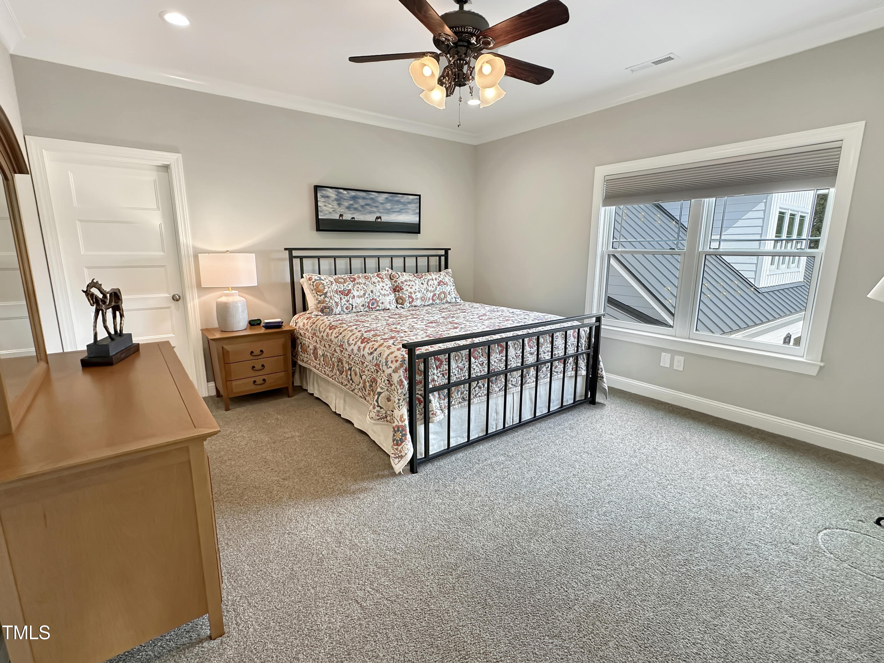 8589 McGhees Mill Road Semora, NC 27343 - Photo 30 of 67 a bed room with a bed and a chandelier