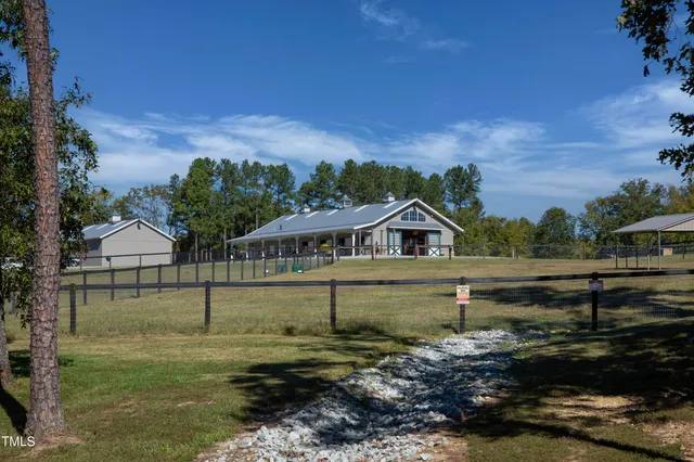 a view of a house with a yard and a table
