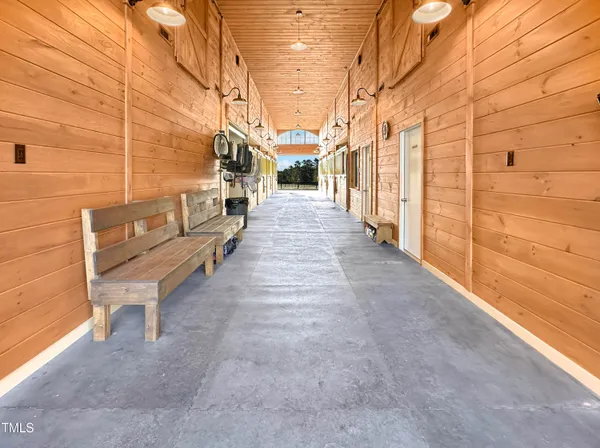 a small white house with a small yard and wooden fence