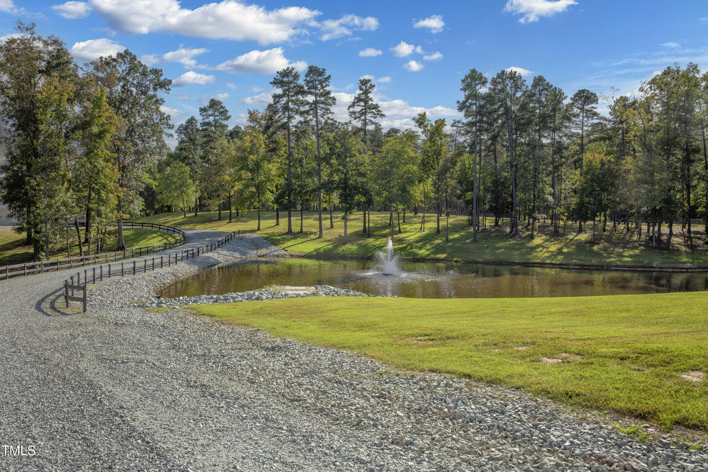 8589 McGhees Mill Road Semora, NC 27343 - Photo 54 of 67 a view of a swimming pool with an outdoor seating and trees in the background