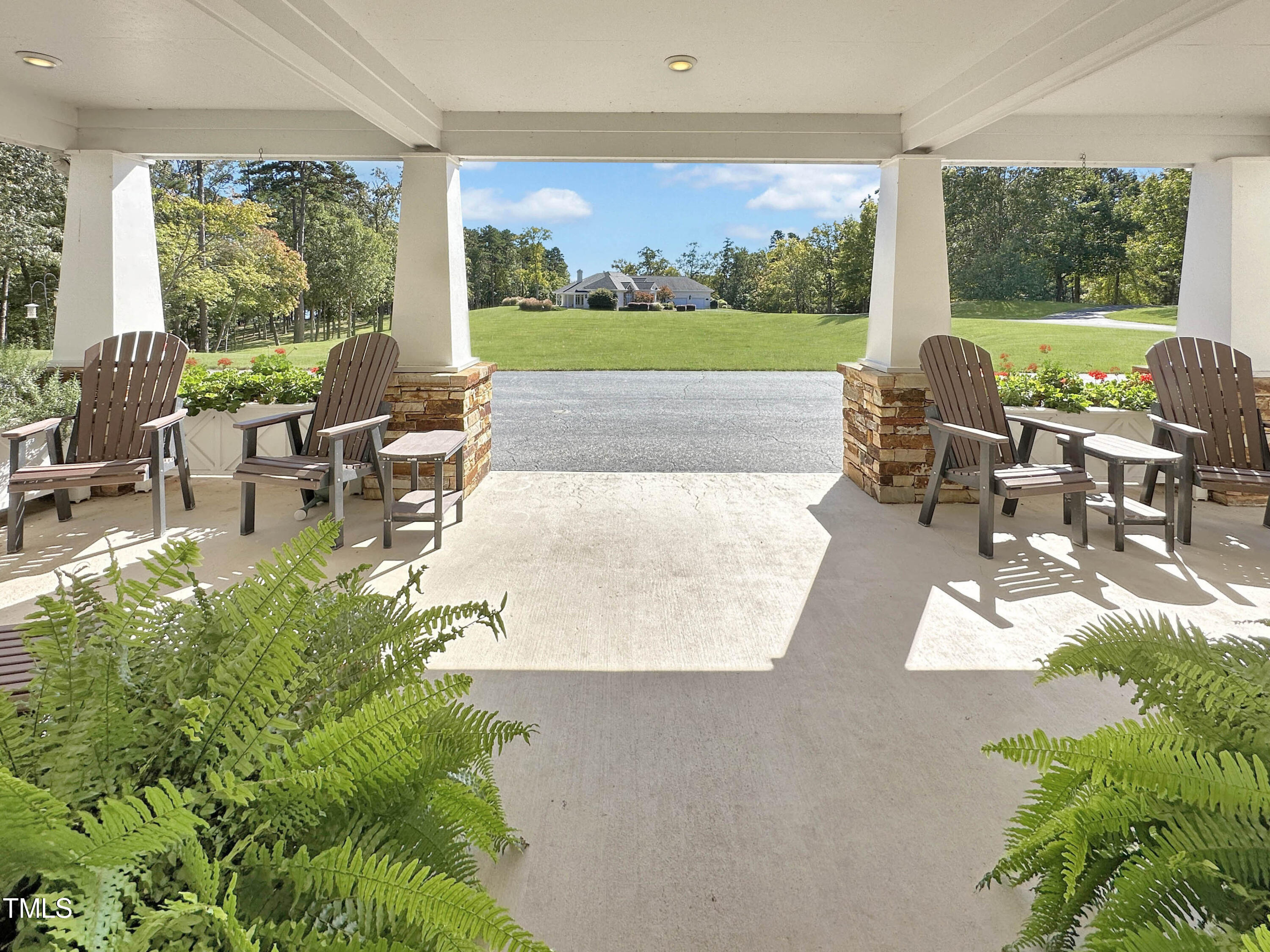 8589 McGhees Mill Road Semora, NC 27343 - Photo 58 of 67 a view of a patio with couches chairs and a big yard