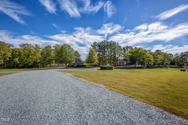 a living room with furniture and view of kitchen