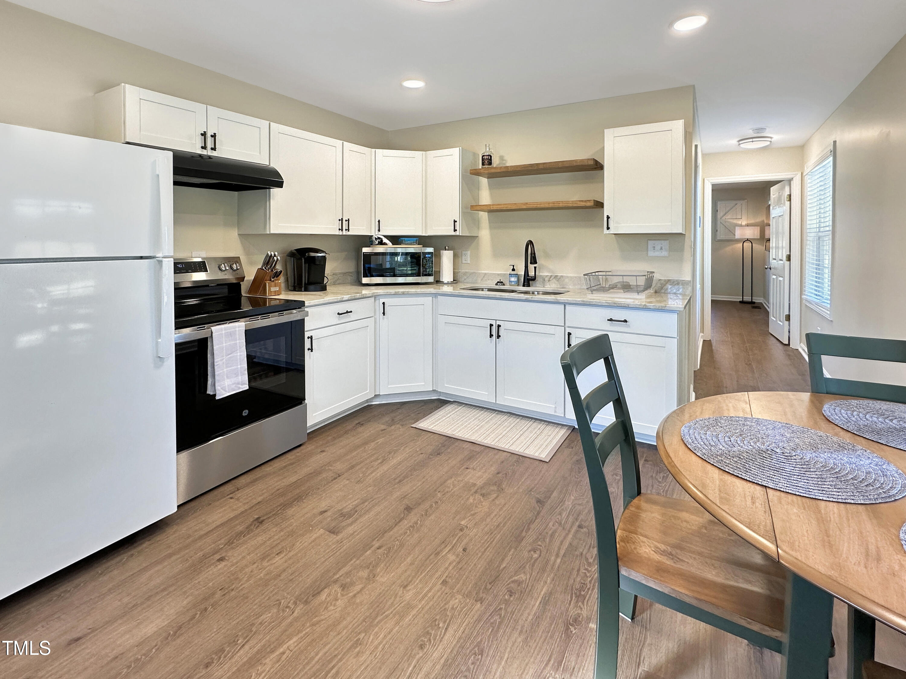 8589 McGhees Mill Road Semora, NC 27343 - Photo 65 of 67 a kitchen with stainless steel appliances granite countertop a stove refrigerator sink and cabinets