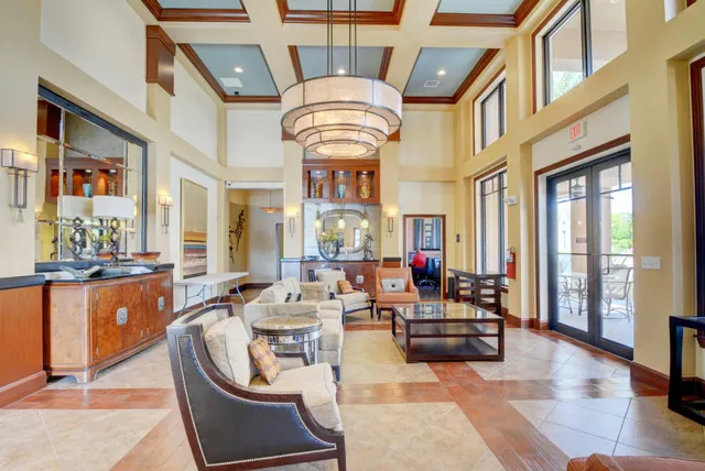 a living room with fireplace furniture and a large window