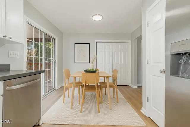 a kitchen with granite countertop a refrigerator and a stove top oven