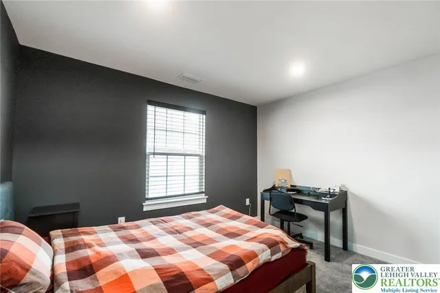 a bed room with a bed and a flat screen tv