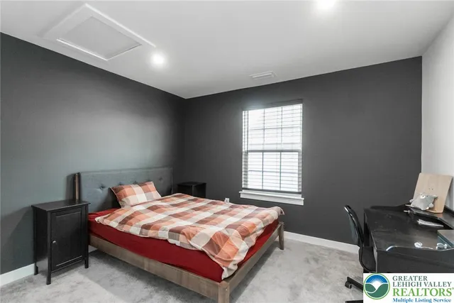 a bedroom with a bed and window