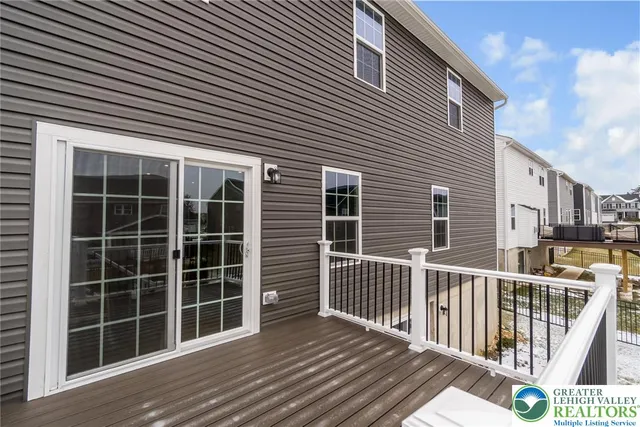 a large kitchen with stainless steel appliances a sink a stove and a refrigerator