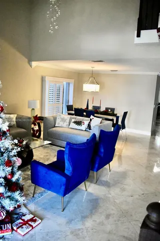 a living room with furniture a couch and a potted plant