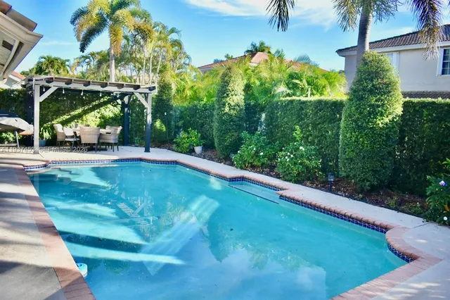 a living room with a bed and a book shelf