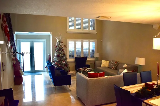 a living room with furniture window and wooden floor
