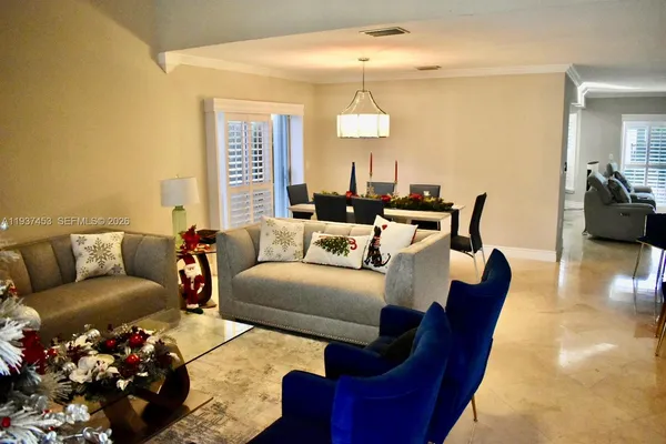 a living room with furniture and a chandelier
