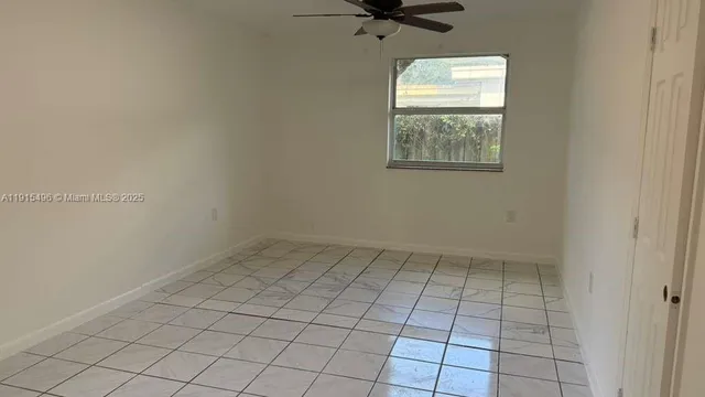 a view of an empty room and a bathroom