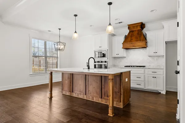 a view of empty room with wooden floor and fireplace