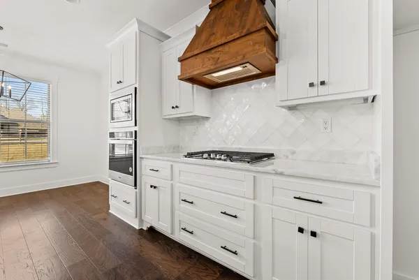 a kitchen with stainless steel appliances a stove a sink and a refrigerator