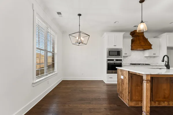 a kitchen with stainless steel appliances white cabinets and a stove