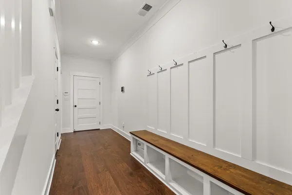 a kitchen with stainless steel appliances granite countertop a sink a stove and a wooden floors