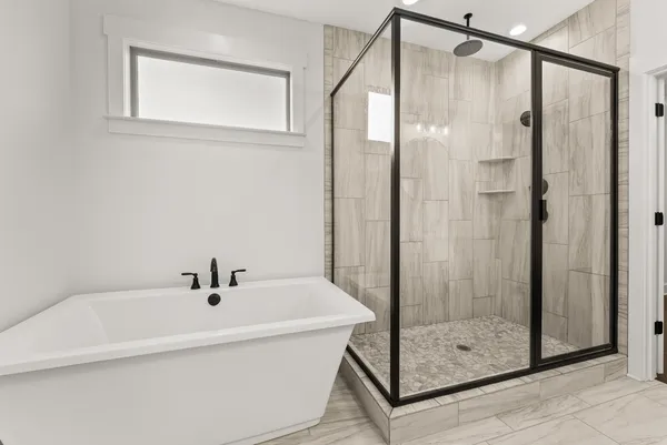 a bathroom with a bathtub and shower