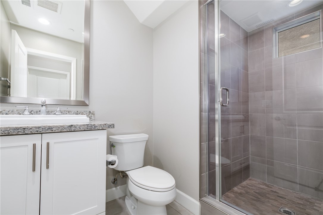 155 Blue Crystal Drive Walnut, CA 91789 - Photo 3 of 14 a bathroom with a granite countertop sink a toilet and shower