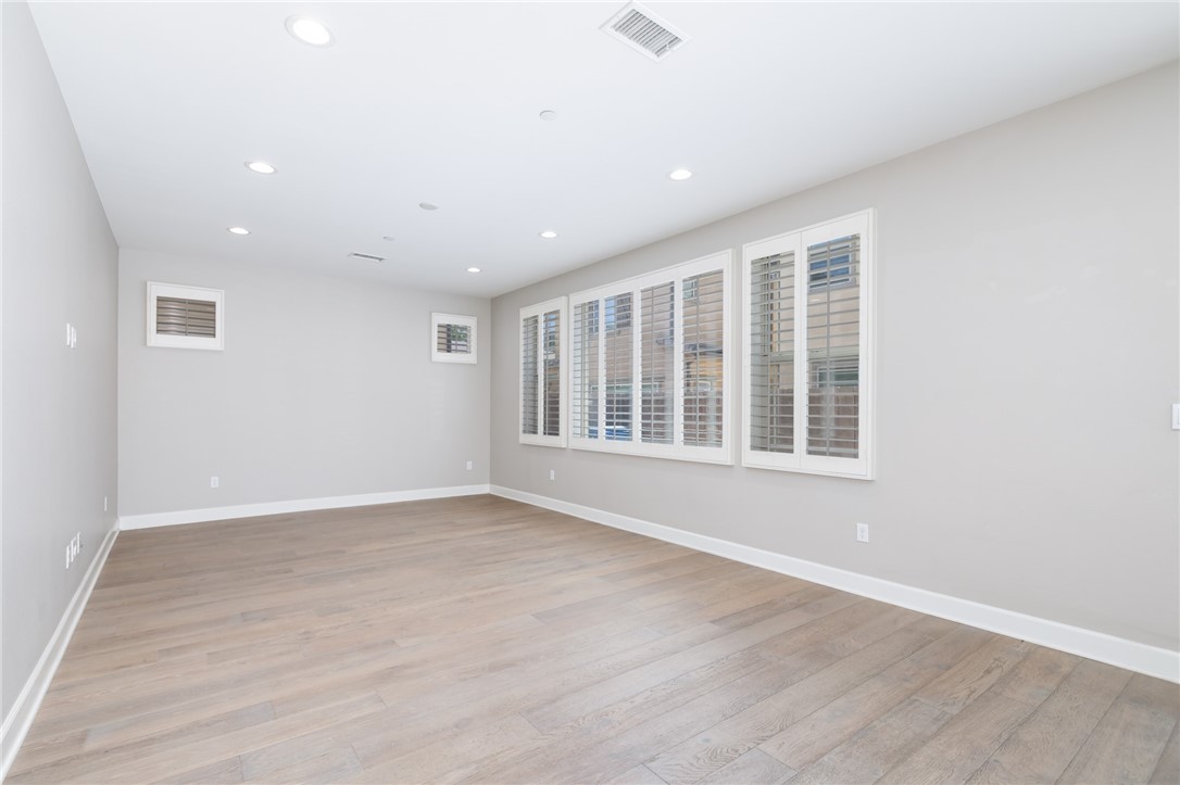 155 Blue Crystal Drive Walnut, CA 91789 - Photo 4 of 14 an empty room with wooden floor and windows