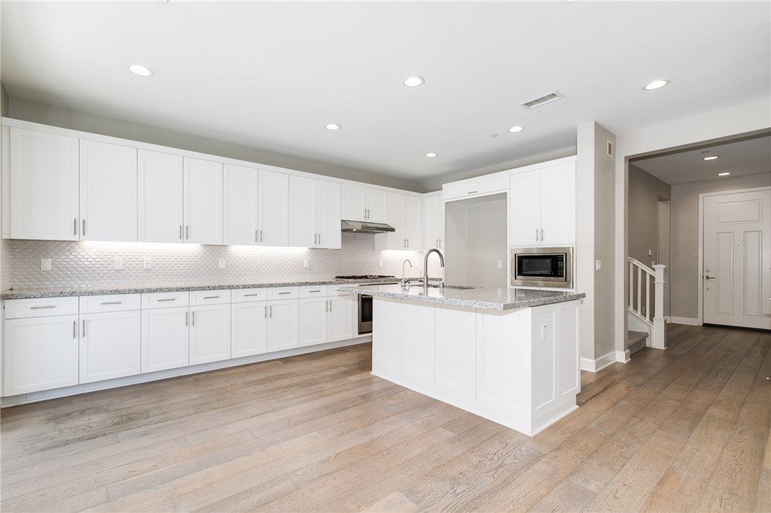 155 Blue Crystal Drive Walnut, CA 91789 - Photo 5 of 14 a kitchen with granite countertop a white stove top oven and white cabinets
