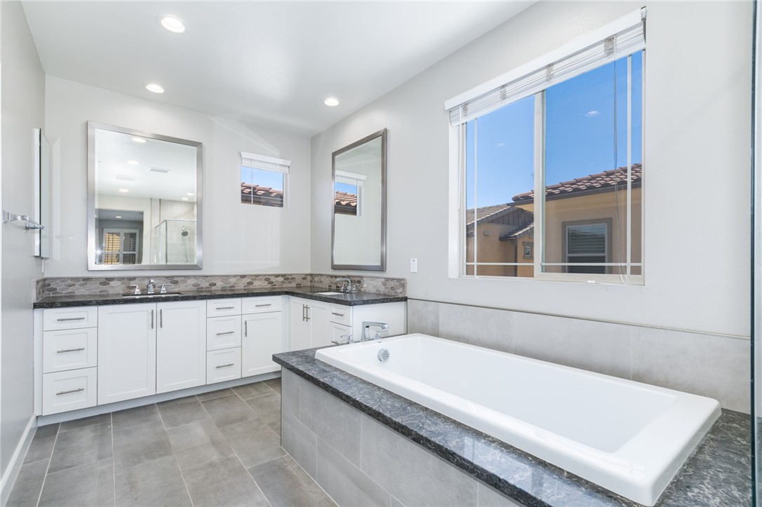 155 Blue Crystal Drive Walnut, CA 91789 - Photo 9 of 14 a bathroom with a granite countertop tub sink and mirror