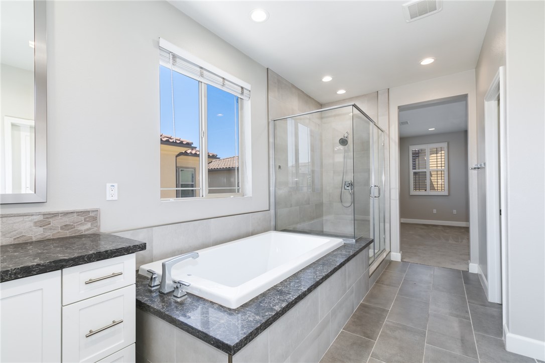 155 Blue Crystal Drive Walnut, CA 91789 - Photo 10 of 14 a spacious bathroom with a granite countertop tub sink and mirror