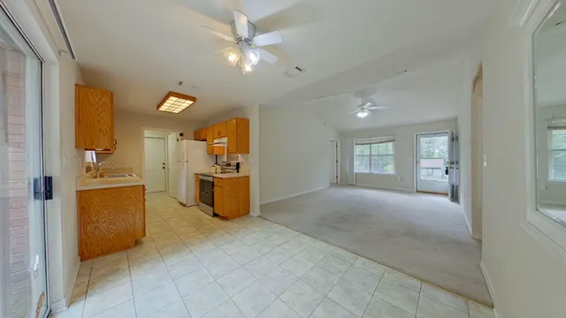 a view of a kitchen with furniture and an empty room