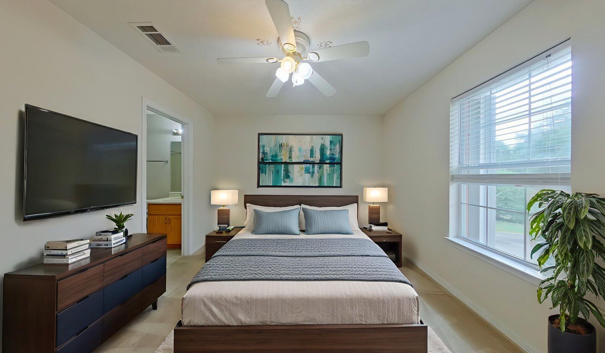 117 Jeff Drive Crestview, FL 32536 - Photo 19 of 33 a bedroom with a bed and a flat screen tv