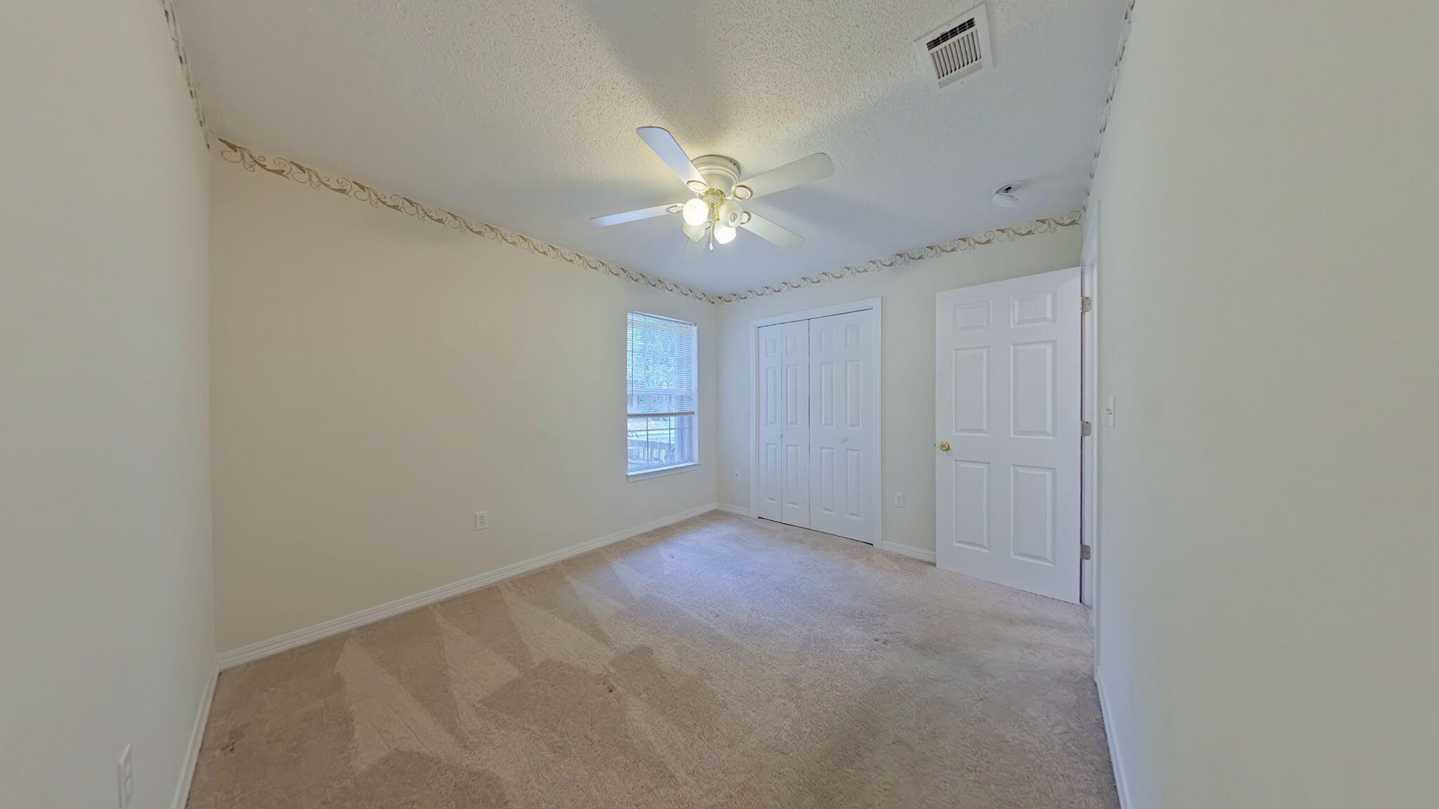 117 Jeff Drive Crestview, FL 32536 - Photo 26 of 33 an empty room with a window and a fan