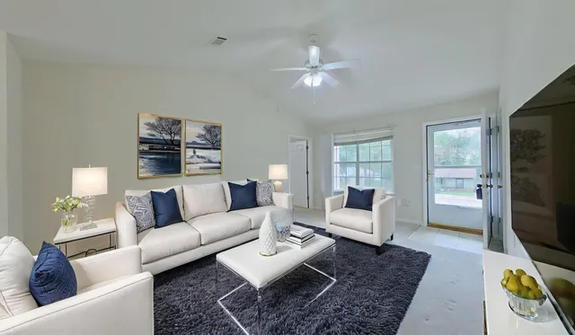 a living room with furniture and a flat screen tv