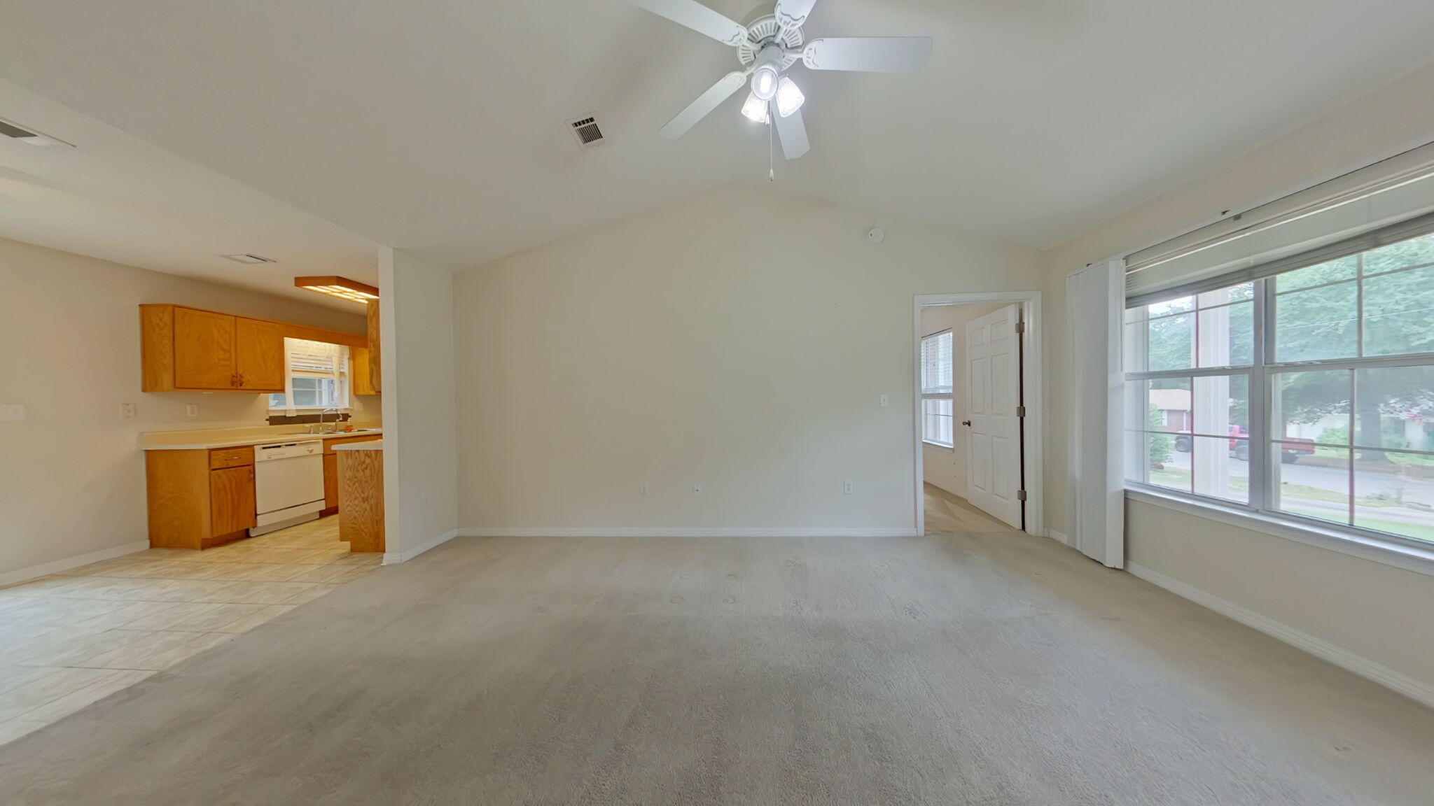 117 Jeff Drive Crestview, FL 32536 - Photo 9 of 33 an empty room with chandelier fan and windows