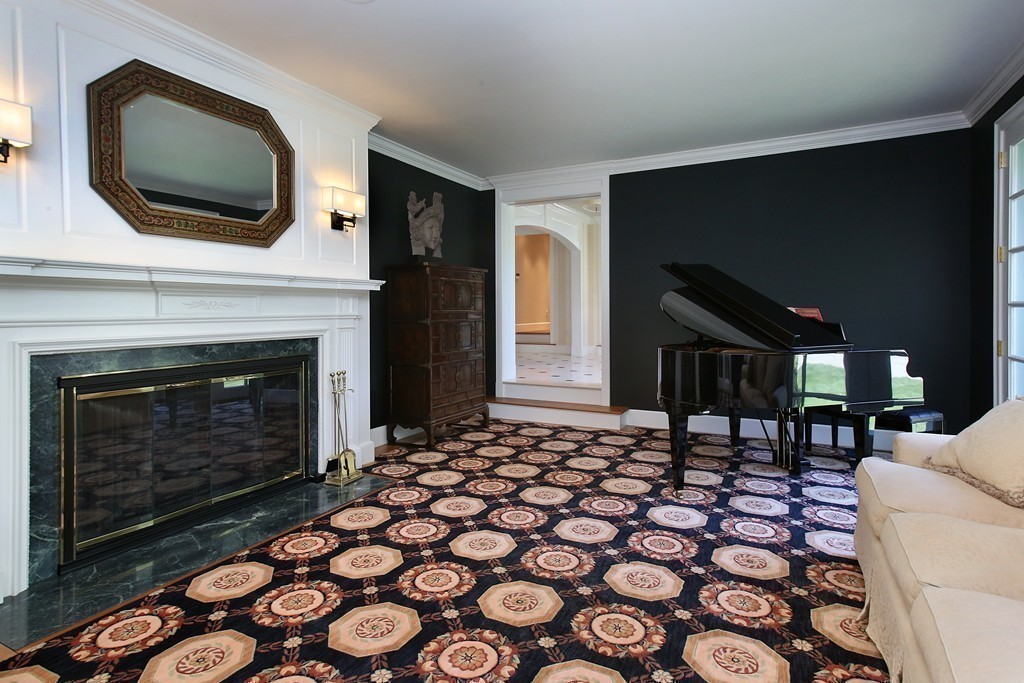 466 Glen Road Weston, MA 02493 - Photo 20 of 27 a living room with furniture a flat screen tv and a fireplace