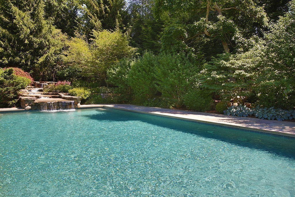 466 Glen Road Weston, MA 02493 - Photo 23 of 27 a backyard of a house with lots of green space and fountain