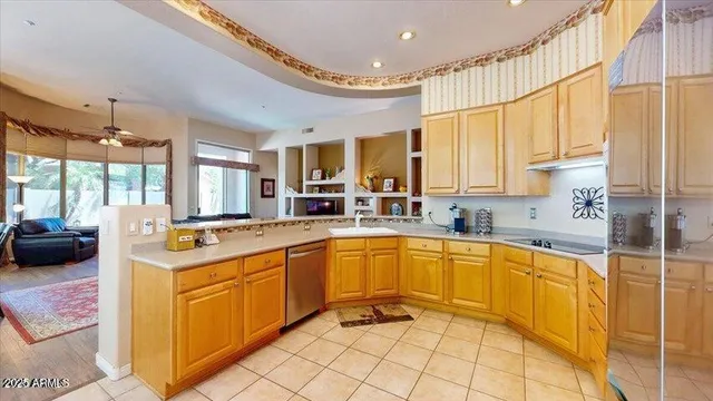 a large kitchen with stainless steel appliances granite countertop a sink and cabinets