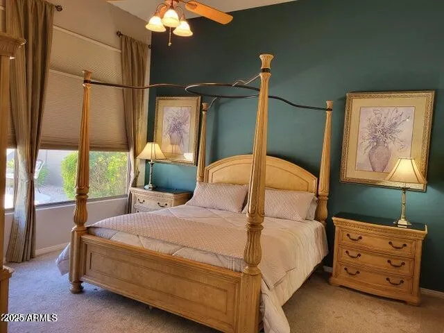 a bedroom with a bed a dresser next to a window