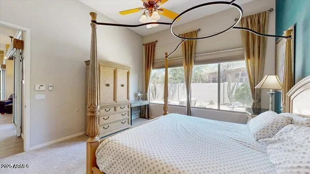 a bedroom with a large bed and a chandelier
