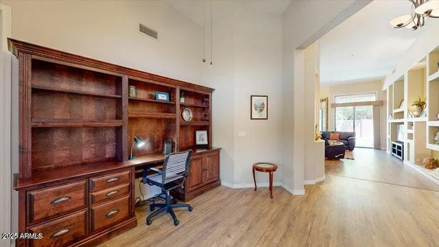 a view of a workspace with furniture and wooden floor