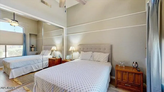 a bedroom with double bed and a window