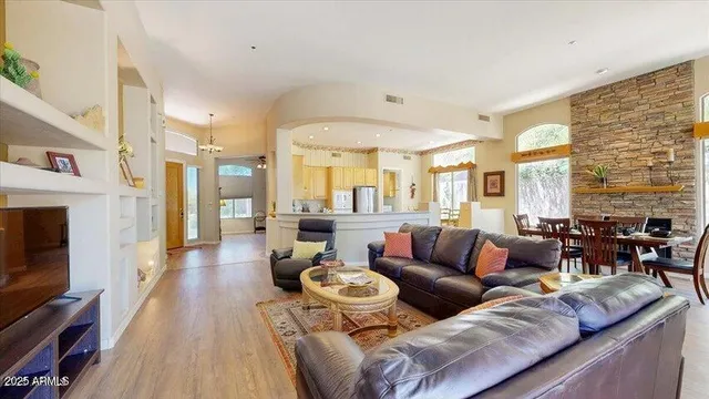 a living room with furniture a fireplace and a flat screen tv