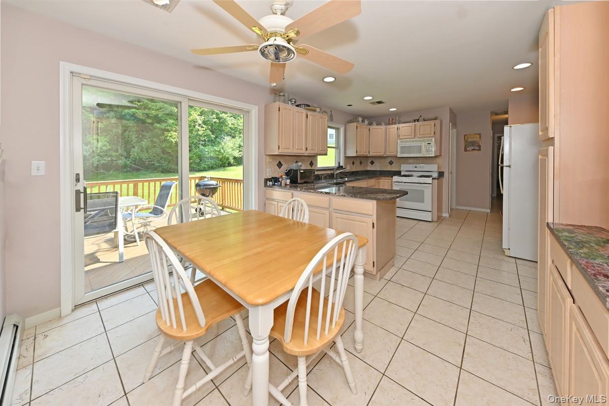 14 Roble Road Suffern, NY 10901 - Photo 10 of 30 Dining area featuring light tile patterned floors, recessed lighting, a baseboard radiator, and a ceiling fan