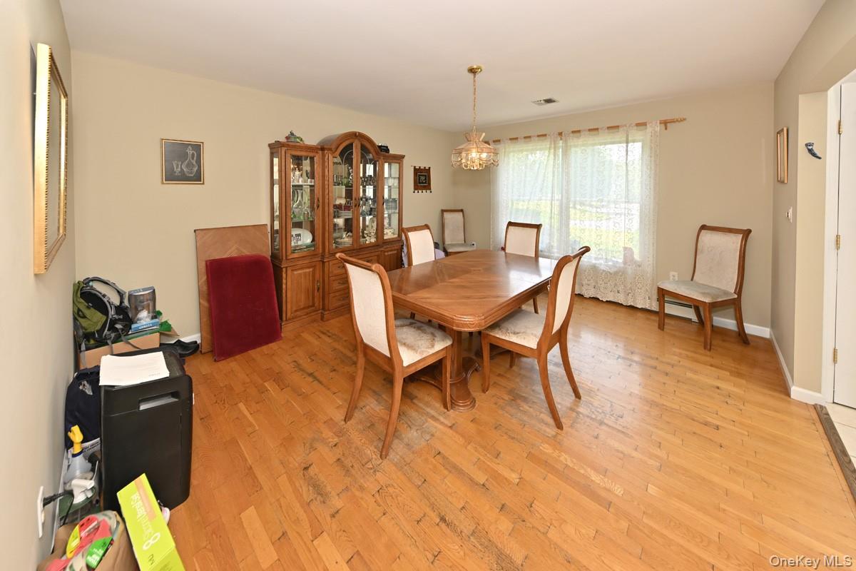 14 Roble Road Suffern, NY 10901 - Photo 14 of 30 Dining room featuring light wood finished floors and a chandelier
