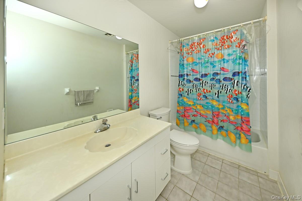 14 Roble Road Suffern, NY 10901 - Photo 23 of 30 Bathroom featuring vanity, tile patterned flooring, and shower / bath combination with curtain