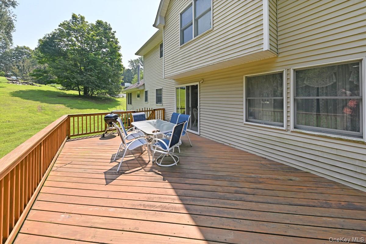 14 Roble Road Suffern, NY 10901 - Photo 26 of 30 Deck featuring outdoor dining area and a lawn