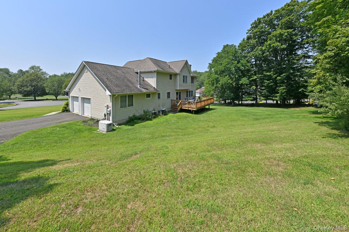 14 Roble Road Suffern, NY 10901 - Photo 5 of 30 View of side of home with a lawn, driveway, a deck, and view of scattered trees